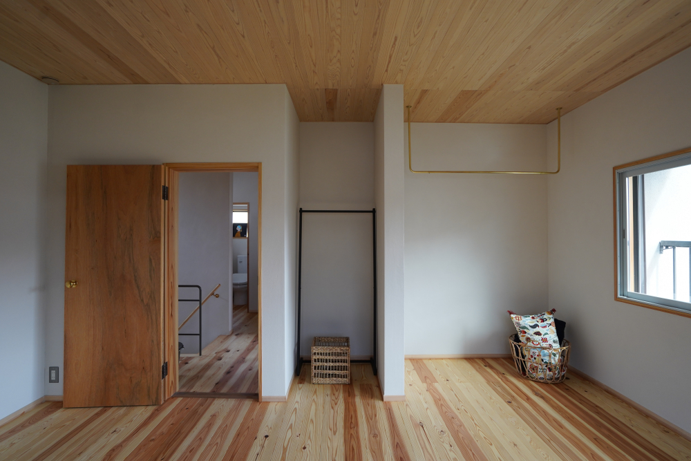 子ども部屋はもともとの収納扉をとり、真鍮のハンガーパイプを設置した。